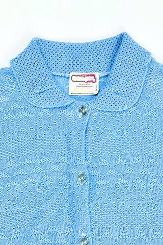Vintage 1970s blue cardigan sweater with detailed eyelet knit in a variety of different stitches. Features a Peter Pan collar, clear plastic buttons, and ribbed sleeve cuffs and waistband, similar to a sweatshirt.

Designed by Excelsior Knitting Mills. Made in Canada.