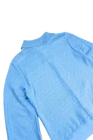 Vintage 1970s blue cardigan sweater with detailed eyelet knit in a variety of different stitches. Features a Peter Pan collar, clear plastic buttons, and ribbed sleeve cuffs and waistband, similar to a sweatshirt.

Designed by Excelsior Knitting Mills. Made in Canada.