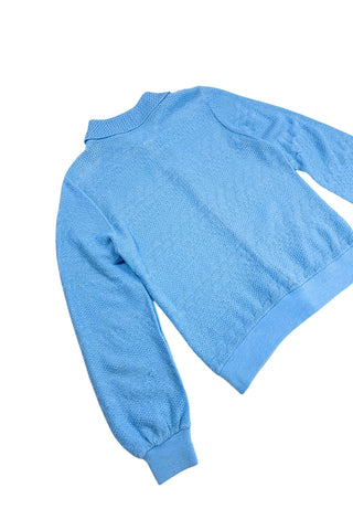 Vintage 1970s blue cardigan sweater with detailed eyelet knit in a variety of different stitches. Features a Peter Pan collar, clear plastic buttons, and ribbed sleeve cuffs and waistband, similar to a sweatshirt.

Designed by Excelsior Knitting Mills. Made in Canada.
