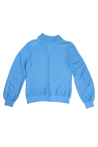 Vintage 1970s blue cardigan sweater with detailed eyelet knit in a variety of different stitches. Features a Peter Pan collar, clear plastic buttons, and ribbed sleeve cuffs and waistband, similar to a sweatshirt.

Designed by Excelsior Knitting Mills. Made in Canada.