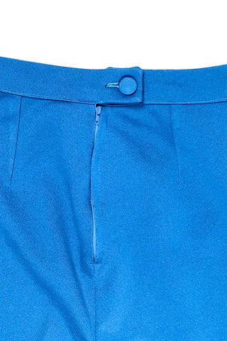 These vintage 1970s ladies’ trousers in peacock blue have the perfect true straight leg cut, providing an authentic 70s fit and flare shape when worn. The slight stretch of the medium-weight polyester fabric hugs your curves in all the right places. The trousers fasten in the back with a back zipper and self-fabric button closure. Unlined.