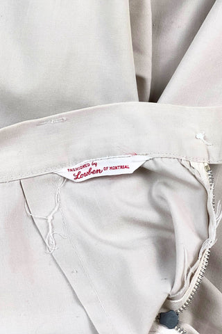 Vintage 1950s shorts in light beige cotton with front pin tuck sewn pleat accents and small belt loops. The shorts close in the side with a metal zipper and button closure and are unlined.

Designed with a high waist fit, with long and lean leg openings, hitting at the lower mid thigh.

Fashioned by Louben of Montreal. Made in Canada.