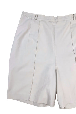 Vintage 1950s shorts in light beige cotton with front pin tuck sewn pleat accents and small belt loops. The shorts close in the side with a metal zipper and button closure and are unlined.

Designed with a high waist fit, with long and lean leg openings, hitting at the lower mid thigh.

Fashioned by Louben of Montreal. Made in Canada.
