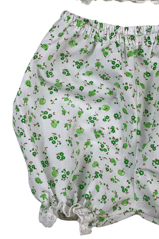 Vintage 1970s baby dress set of apron dress and bloomers with green apple blossom print. The top and hem of the apron, as well as the leg openings of the bloomers, are trimmed with tiny white lace.

Marked size 18. 65% polyester, 35% cotton.