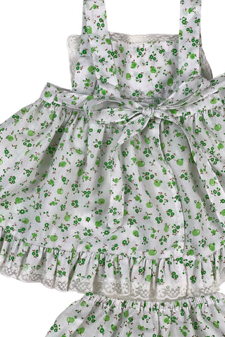 Vintage 1970s baby dress set of apron dress and bloomers with green apple blossom print. The top and hem of the apron, as well as the leg openings of the bloomers, are trimmed with tiny white lace.

Marked size 18. 65% polyester, 35% cotton.