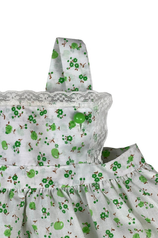 Vintage 1970s baby dress set of apron dress and bloomers with green apple blossom print. The top and hem of the apron, as well as the leg openings of the bloomers, are trimmed with tiny white lace.

Marked size 18. 65% polyester, 35% cotton.