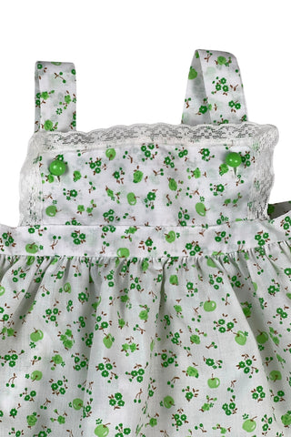 Vintage 1970s baby dress set of apron dress and bloomers with green apple blossom print. The top and hem of the apron, as well as the leg openings of the bloomers, are trimmed with tiny white lace.

Marked size 18. 65% polyester, 35% cotton.