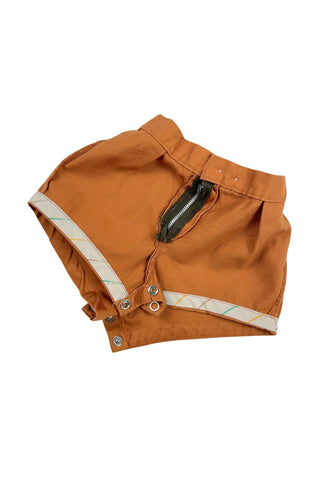 Vintage 1950s baby shorts in caramel brown cotton, with metal zipper fly and two button waist closure. The leg openings are faced with white yellow and green striped twill tape. The bottom of the shorts has a metal snap closure.

The perfect short for your tiniest camper this summer!