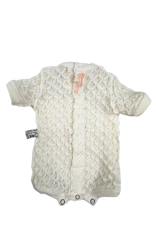 Vintage 1960s baby onesie bodysuit of cream crochet knit in a textural layered petal stitch. This beautiful and special piece would be perfect for baby’s layette.

Features a cord tie at the waist, which ties in a bow. The onesie closes in the back with five buttons up the back, and also has snap closures at the bottom.

Designed by Renzo. Made in Italy.