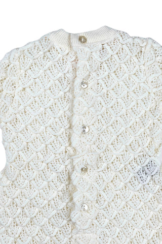 Vintage 1960s baby onesie bodysuit of cream crochet knit in a textural layered petal stitch. This beautiful and special piece would be perfect for baby’s layette.

Features a cord tie at the waist, which ties in a bow. The onesie closes in the back with five buttons up the back, and also has snap closures at the bottom.

Designed by Renzo. Made in Italy.