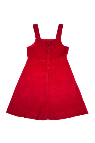 Vintage 1970s girls’ jumper dress in red cotton corduroy with decorative gold buckles across the bodice. Features a classic A-line silhouette with wide shoulder straps.

Designed by Encore. Made in Canada.

85% cotton, 15% polyester.