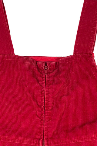 Vintage 1970s girls’ jumper dress in red cotton corduroy with decorative gold buckles across the bodice. Features a classic A-line silhouette with wide shoulder straps.

Designed by Encore. Made in Canada.

85% cotton, 15% polyester.