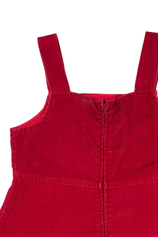 Vintage 1970s girls’ jumper dress in red cotton corduroy with decorative gold buckles across the bodice. Features a classic A-line silhouette with wide shoulder straps.

Designed by Encore. Made in Canada.

85% cotton, 15% polyester.