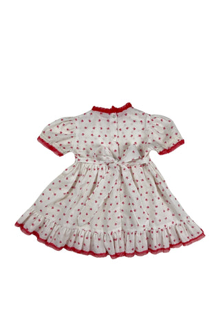Vintage 1970s baby dress set with insect print. The set includes a dress, matching bloomers, and a red velvet vest with a peplum ruffle. The dress has short, puffed sleeves, a round neckline, and a gathered, full skirt with a back sash bow tie. The collar, cuffs, and hem are trimmed with delicate red lace. 

The dress and vest both close in the back with three pearly buttons.