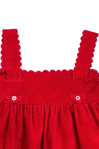 Vintage 1970s toddler dress in red cotton corduroy, with scalloped straps.

The jumper-style dress features straps that weave through the bodice yoke and peek out the bottom to button onto the chest.

By Selo. Made in Valencia, Spain.

Marked size 2.