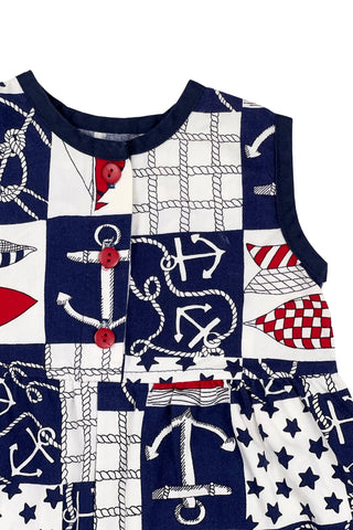 Vintage 1980s baby onesie ‘bubble’ romper in a cotton nautical print. Accented with navy trim around the collar and arm openings, and finished with three red buttons down the chest. Closes with three red buttons on the bottom.