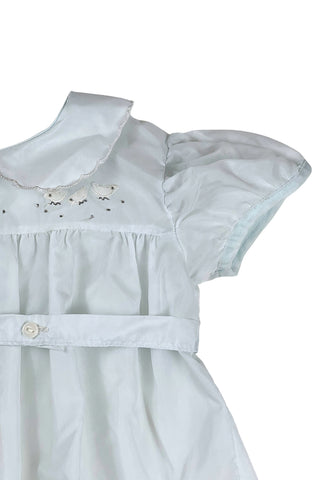 Vintage 1960s baby ‘bubble’ onesie in light blue acetate with a sweet bird appliqué design across the chest. Features a scalloped Peter Pan collar, short, puffed sleeves, and a buttoned belt at the waist.

The leg openings are elasticized. The onesie closes at the bottom with two buttons.