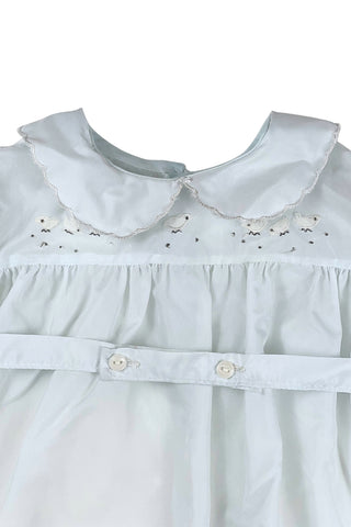 Vintage 1960s baby ‘bubble’ onesie in light blue acetate with a sweet bird appliqué design across the chest. Features a scalloped Peter Pan collar, short, puffed sleeves, and a buttoned belt at the waist.

The leg openings are elasticized. The onesie closes at the bottom with two buttons.