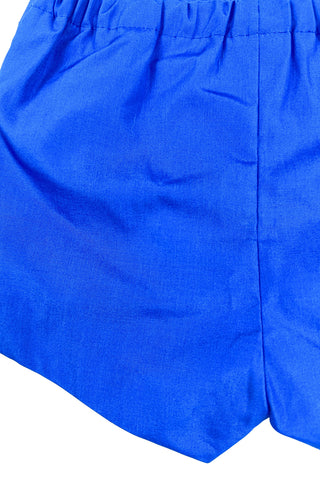 Vintage 1960s baby shorts with inner plastic diaper cover lining (which can easily be cut out, if you prefer). The shorts are made of a poly/cotton blend in bright royal blue, and features a faux fly placket on the front, and pin tucks down the legs. The waist is elasticized.

Marked size 12 months. Made in the Philippines.