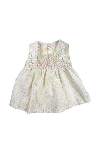 This vintage cotton baby dress is sleeveless and features smocking across the chest, and is accented with a small pink bow. The dress closes in the back with four ivory buttons.

Condition note: There is some light yellow general staining on the chest, but it is very subtle, and could likely be removed with stain treatment.