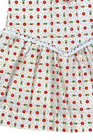 Vintage 1960s toddler girls’ white sleeveless dress featuring a red, yellow, and green floral pattern with white eyelet lace trim.

Made in Austria.