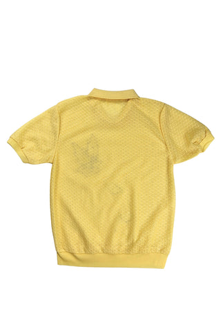 Vintage 1980s short sleeve sweater with ribbed collar and cuffs in sunny yellow tiny eyelet knit with a white leaf appliqué accented with a rhinestone center.