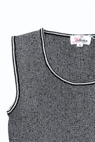 Vintage 1970s sweater vest in silver metallic knit, with black striped accents around the low, round collar and sleeveless arm openings.

Designed by The Kollection. Made in Canada.

Marked size Small.