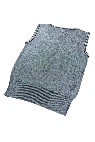 Vintage 1970s sweater vest in silver metallic knit, with black striped accents around the low, round collar and sleeveless arm openings.

Designed by The Kollection. Made in Canada.

Marked size Small.