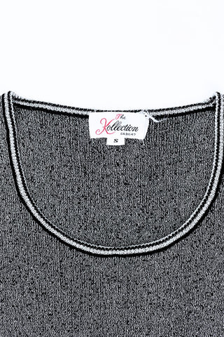 Vintage 1970s sweater vest in silver metallic knit, with black striped accents around the low, round collar and sleeveless arm openings.

Designed by The Kollection. Made in Canada.

Marked size Small.