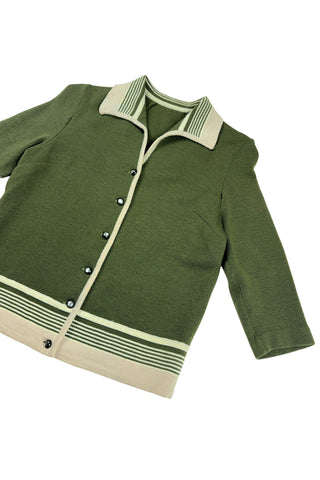 Vintage 1950s wool cardigan sweater in olive green and cream with three-quarter length sleeves. The sweater features a rolled collar with a striped design, with a matching striped band at the waist. Closes with six green lucite buttons.