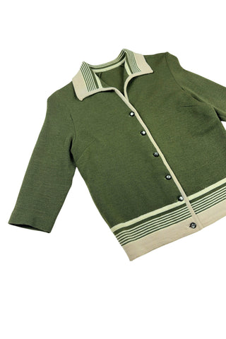 Vintage 1950s wool cardigan sweater in olive green and cream with three-quarter length sleeves. The sweater features a rolled collar with a striped design, with a matching striped band at the waist. Closes with six green lucite buttons.