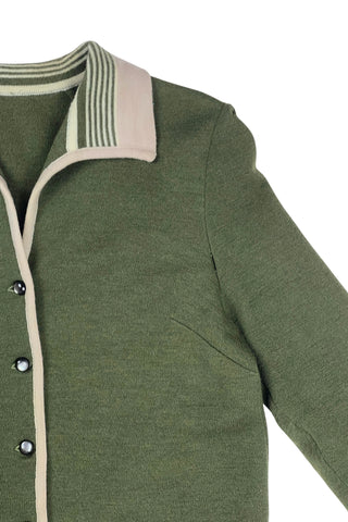Vintage 1950s wool cardigan sweater in olive green and cream with three-quarter length sleeves. The sweater features a rolled collar with a striped design, with a matching striped band at the waist. Closes with six green lucite buttons.