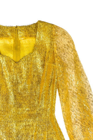 Vintage 1960s gold fringe bodysuit costume with long cuffed sheer lace sleeves and a sweetheart neckline. The hourglass cut of the non-stretch gold material keeps all your curves in place in a classic bombshell shape.

The costume closes in the back with a long cotton twill zipper. There is no opening at the bottom. The long sleeves close with hook and eye closures instead of buttons.