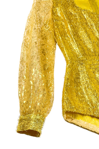 Vintage 1960s gold fringe bodysuit costume with long cuffed sheer lace sleeves and a sweetheart neckline. The hourglass cut of the non-stretch gold material keeps all your curves in place in a classic bombshell shape.

The costume closes in the back with a long cotton twill zipper. There is no opening at the bottom. The long sleeves close with hook and eye closures instead of buttons.