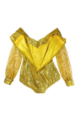 Vintage 1960s gold fringe bodysuit costume with long cuffed sheer lace sleeves and a sweetheart neckline. The hourglass cut of the non-stretch gold material keeps all your curves in place in a classic bombshell shape.

The costume closes in the back with a long cotton twill zipper. There is no opening at the bottom. The long sleeves close with hook and eye closures instead of buttons.