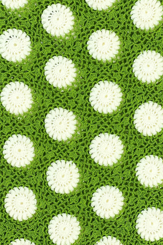 Vintage 1960s crochet sweater top in avocado green with white daisy polkadot pattern. The sweater features a scalloped V-neckline, short sleeves, and a scalloped, pointed hem.