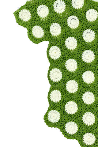 Vintage 1960s crochet sweater top in avocado green with white daisy polkadot pattern. The sweater features a scalloped V-neckline, short sleeves, and a scalloped, pointed hem.