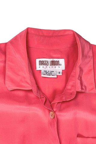 Vintage 1980s Maggy London Petites short sleeve jumpsuit in salmon pink 100% silk. This one piece jumpsuit has an elasticized waist, a zipper fly, and closes with four mother of pearl buttons down the front. One pocket at the chest, and two angled pockets at the hips.

The slightly tapered bottoms hit at the ankle.

Designed by Maggy London Petites. 100% Silk.
