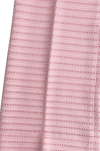 Vintage 1960s women’s trousers in light pink eyelet knit with creased seams and a slight flare at the hem. Elasticized waist.