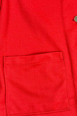 Vintage 1970s tomato red button down shirt, with a pointed collar, long sleeves, and two square patch pockets. The shirt closes with six gold textured buttons down the front, and two matching smaller buttons at the sleeve cuffs.