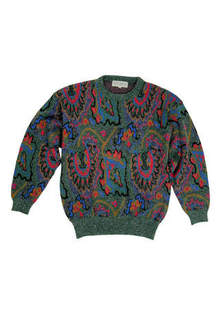 Vintage 1980s French Connection matching set of sweater and skirt in an abstracted paisley pattern. The base of the knit is a green and black heathered knit, with an integrated red, blue, yellow, and black pattern. The knit has an overall fluffiness because of white wispy fibres in the knit blend.

Designed by French Connection. Made in Hong Kong.