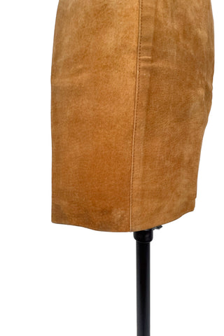 Vintage 1980s suede mini skirt in a light caramel brown colour. The skirt is constructed with a middle panel down the front, and darts in the back to add shape. The skirt closes in the back with a zipper and a snap closure at the waist, and is fully lined.