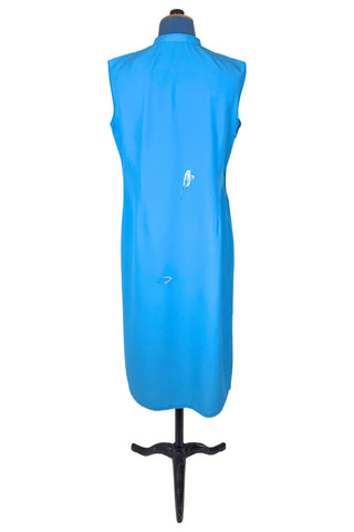 Vintage 1980s cheongsam dress in peacock blue with large white peony flower embroidery. The dress is sleeveless, with a mandarin collar, and closes with three frog closures across the chest, and a side zipper. The dress is unlined.