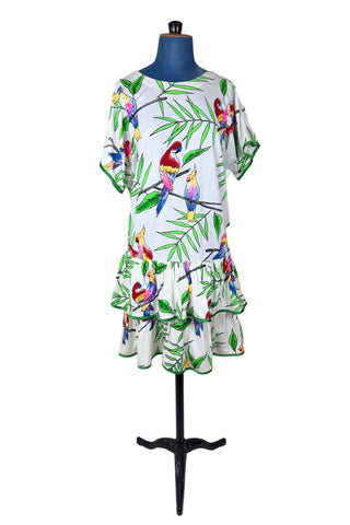 Vintage 1980s dress with tropical parrot and leaf print on soft, mid-weight cotton jersey. Slouchy fit with short sleeves and two-tiered ruffle skirt. The edges of the hem ruffles and sleeves are finished with lime green satin. Perfect for all your summer adventures!

Designed by Himalaya. Made in Hamburg.

Marked size medium.