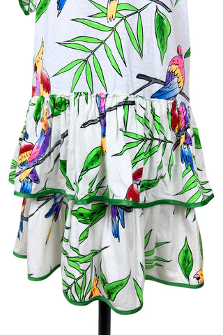 Vintage 1980s dress with tropical parrot and leaf print on soft, mid-weight cotton jersey. Slouchy fit with short sleeves and two-tiered ruffle skirt. The edges of the hem ruffles and sleeves are finished with lime green satin. Perfect for all your summer adventures!

Designed by Himalaya. Made in Hamburg.

Marked size medium.