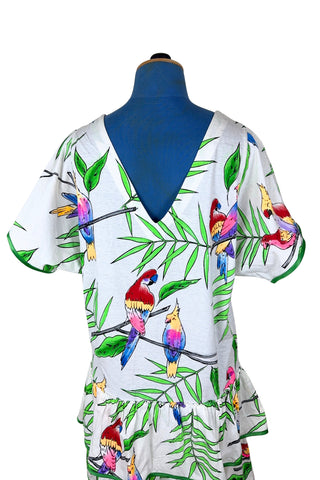 Vintage 1980s dress with tropical parrot and leaf print on soft, mid-weight cotton jersey. Slouchy fit with short sleeves and two-tiered ruffle skirt. The edges of the hem ruffles and sleeves are finished with lime green satin. Perfect for all your summer adventures!

Designed by Himalaya. Made in Hamburg.

Marked size medium.
