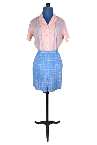 Vintage 1960s blue and white cotton plaid tweed skirt with front kick pleat. The dress closes in the side with a metal Talon zipper, and is unlined.