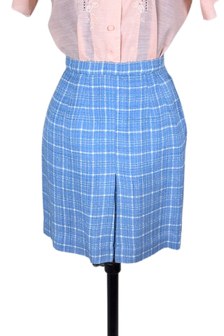 Vintage 1960s blue and white cotton plaid tweed skirt with front kick pleat. The dress closes in the side with a metal Talon zipper, and is unlined.