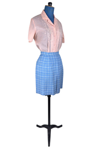 Vintage 1960s blue and white cotton plaid tweed skirt with front kick pleat. The dress closes in the side with a metal Talon zipper, and is unlined.
