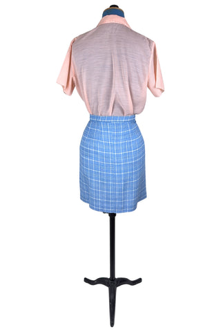 Vintage 1960s blue and white cotton plaid tweed skirt with front kick pleat. The dress closes in the side with a metal Talon zipper, and is unlined.